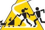 A yellow triangle with people and dogs running around.